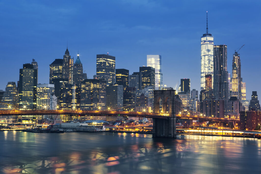 New York City Manhattan midtown at dusk - Best Rate a city skyline with a bridge over water